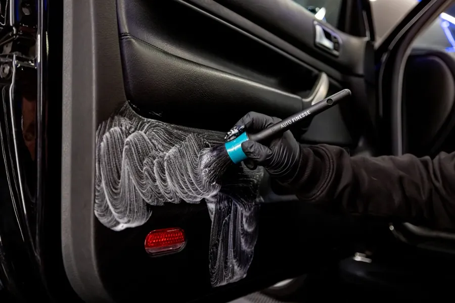 Trim and door cards shampooed with soft detail brushes